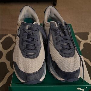 Puma multi-colored blue and white women’s tennis shoes size 11. Loved and worn.